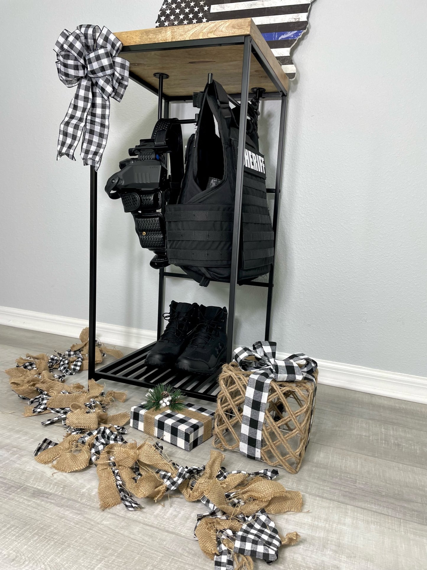 Law enforcement rack with police hanger containing patrol belt and ballistics vest police gift.