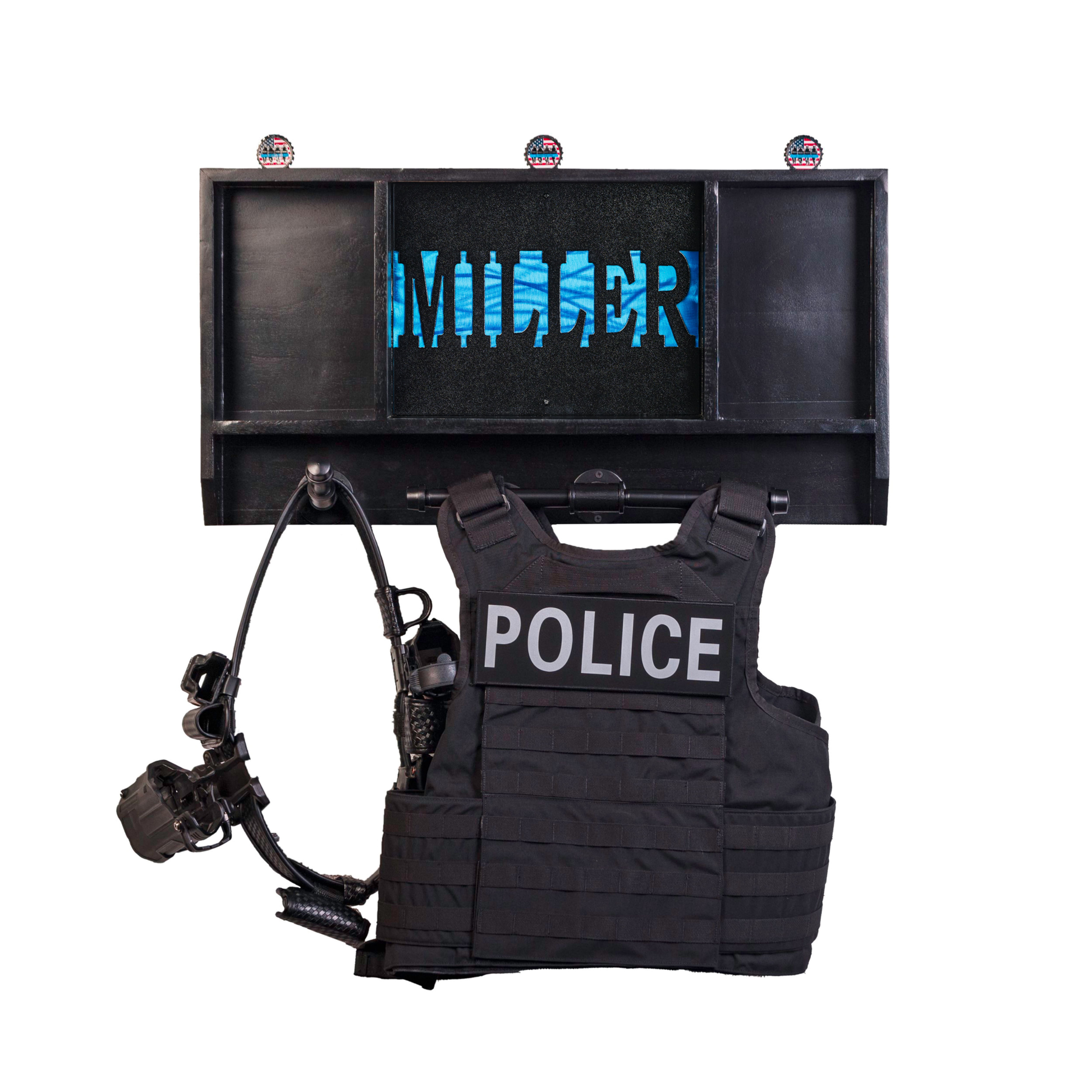 Personalized police gear rack with custom name. The wall rack is storing a patrol vest, duty belt, and challenge coins.