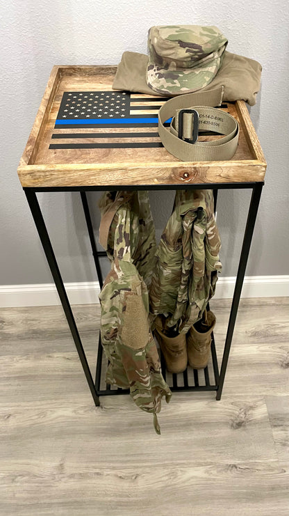 Army gear holder storing military uniforms on tactical hangers.